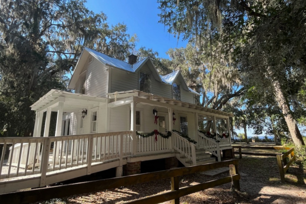 historic white house surrounded by trees