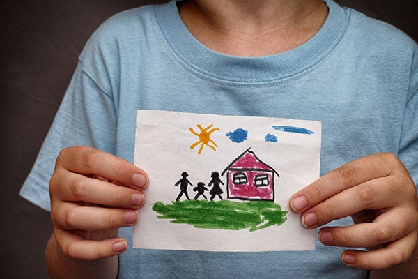 child holding a picture of a family