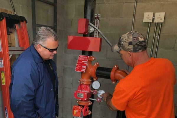 fire inspector examining pipes