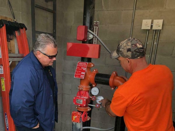 fire inspector examining pipes