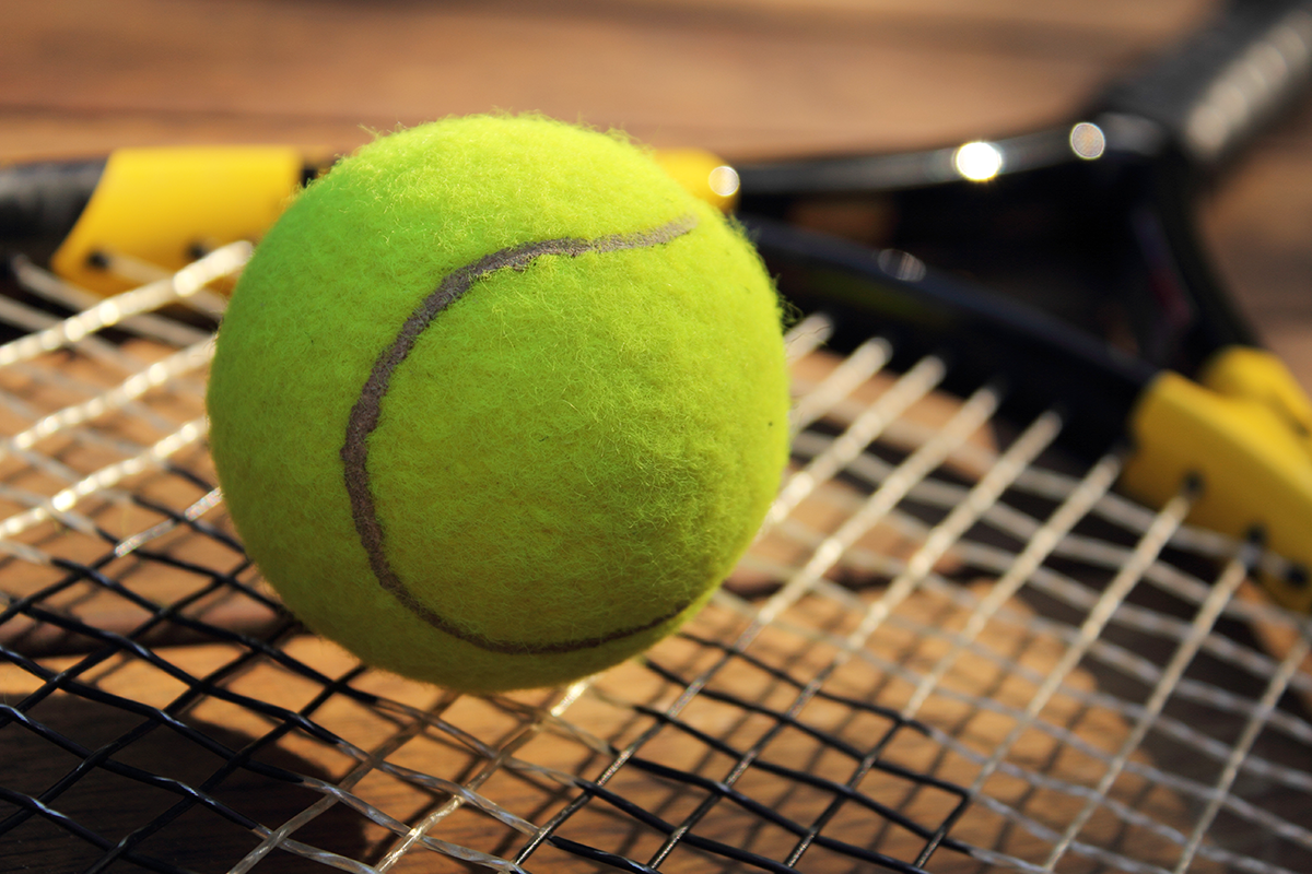 tennis ball on racket