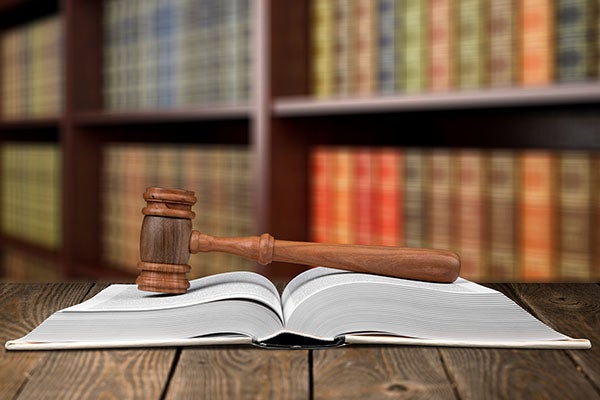 Gavel on an open book in a law library