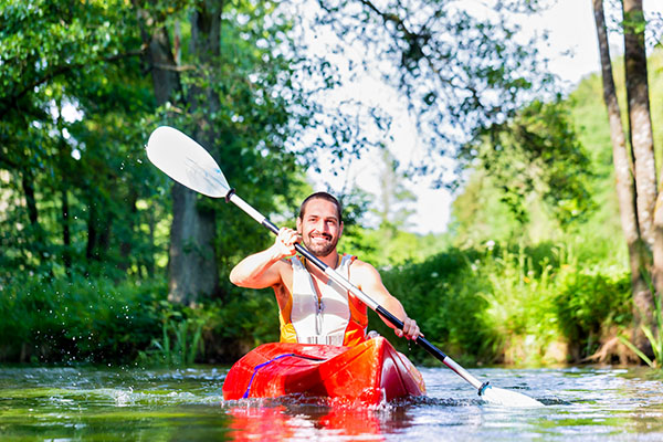 Man kayaking a creek