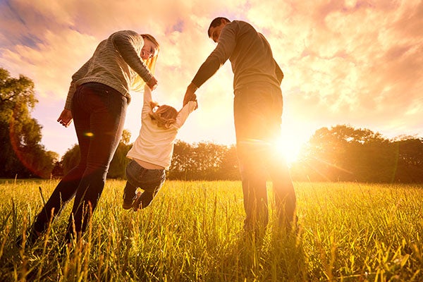 Parents hold a baby's hands