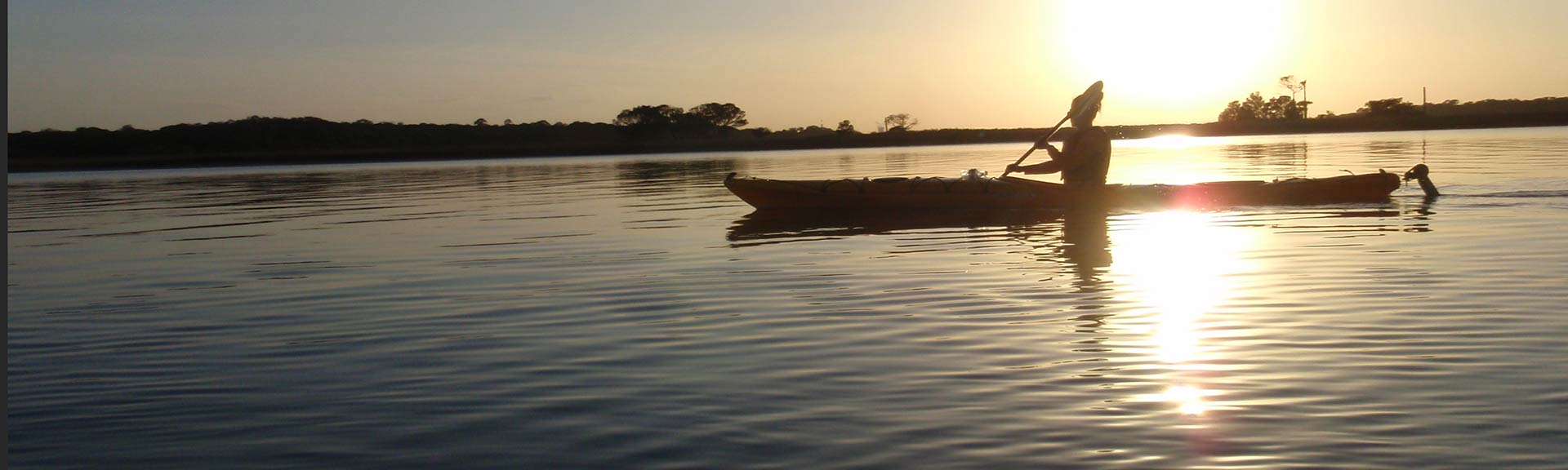 silhouette of canoer at sunset