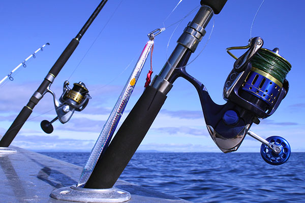 Fishing rods on side of boat on ocean