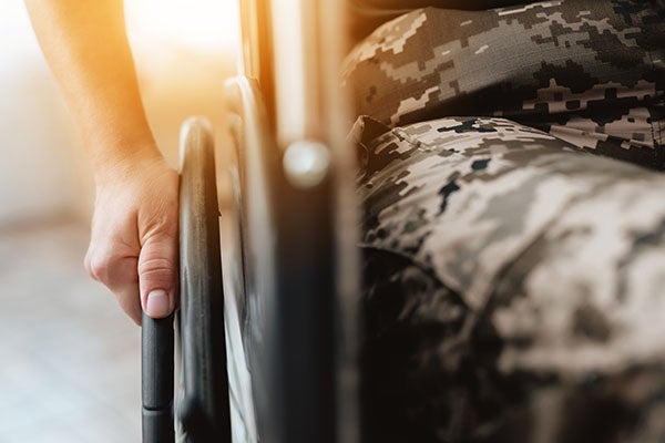 Woman veteran in wheelchair returned from army. 