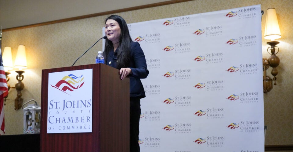 Joy speaking at podium