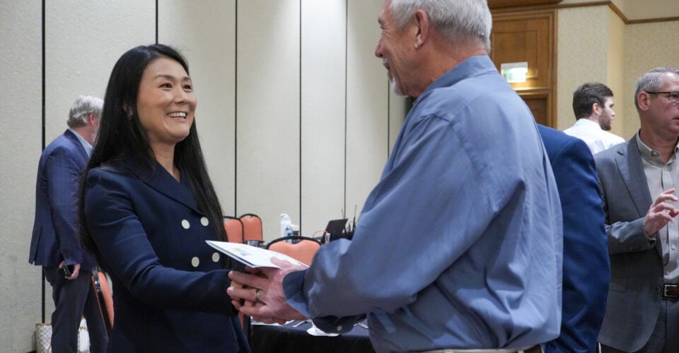 Joy speaking to event attendee