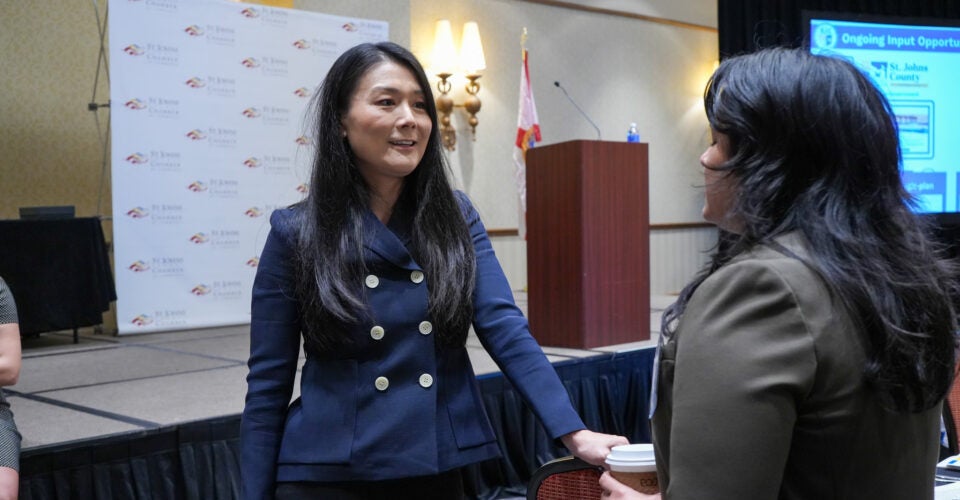 Joy speaking with event attendee