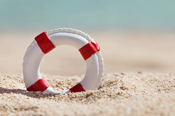 Life saver propped up on a sandy beach