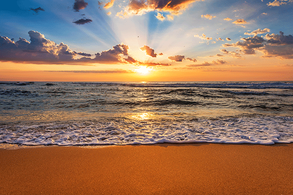 beach sunrise glistening on waves