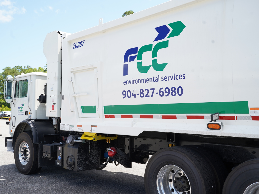 New trash hauler with FCC Environmental Services logo and County number