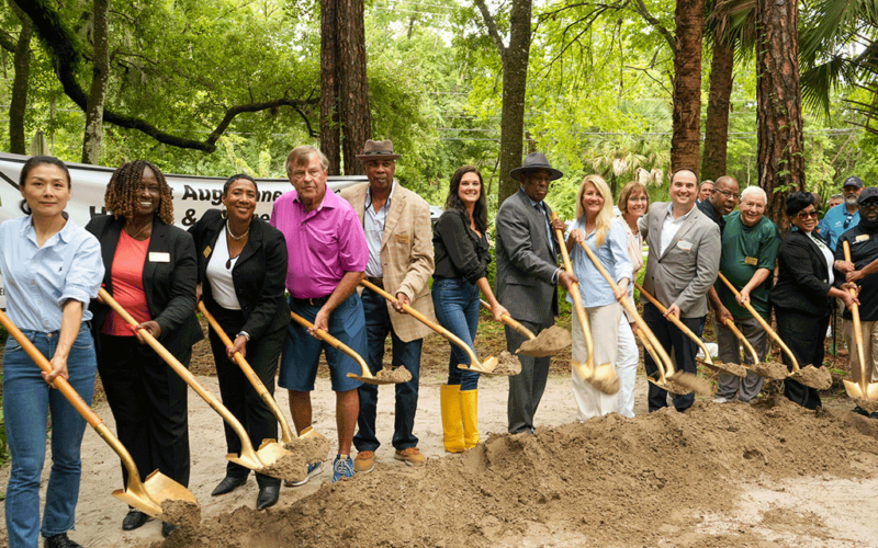 Notable community members hold shovels full of dirt at the West Augustine Health & Wellness Center Groundbreaking