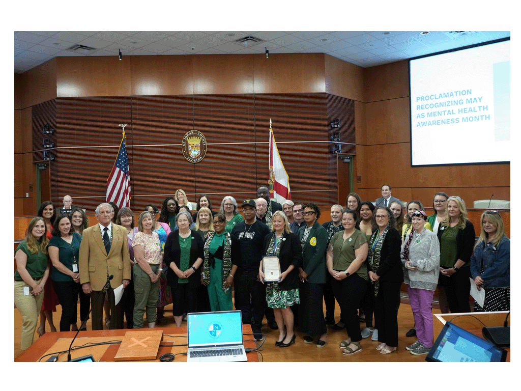 Commissioner Arnold presents the Mental Health Awareness Month proclamation at the April 15 commission meeting,