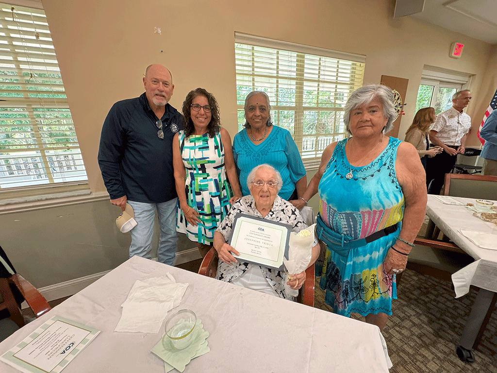 Commissioner Murphy stands with Josephine Trinca, sitting, at 103 years old.