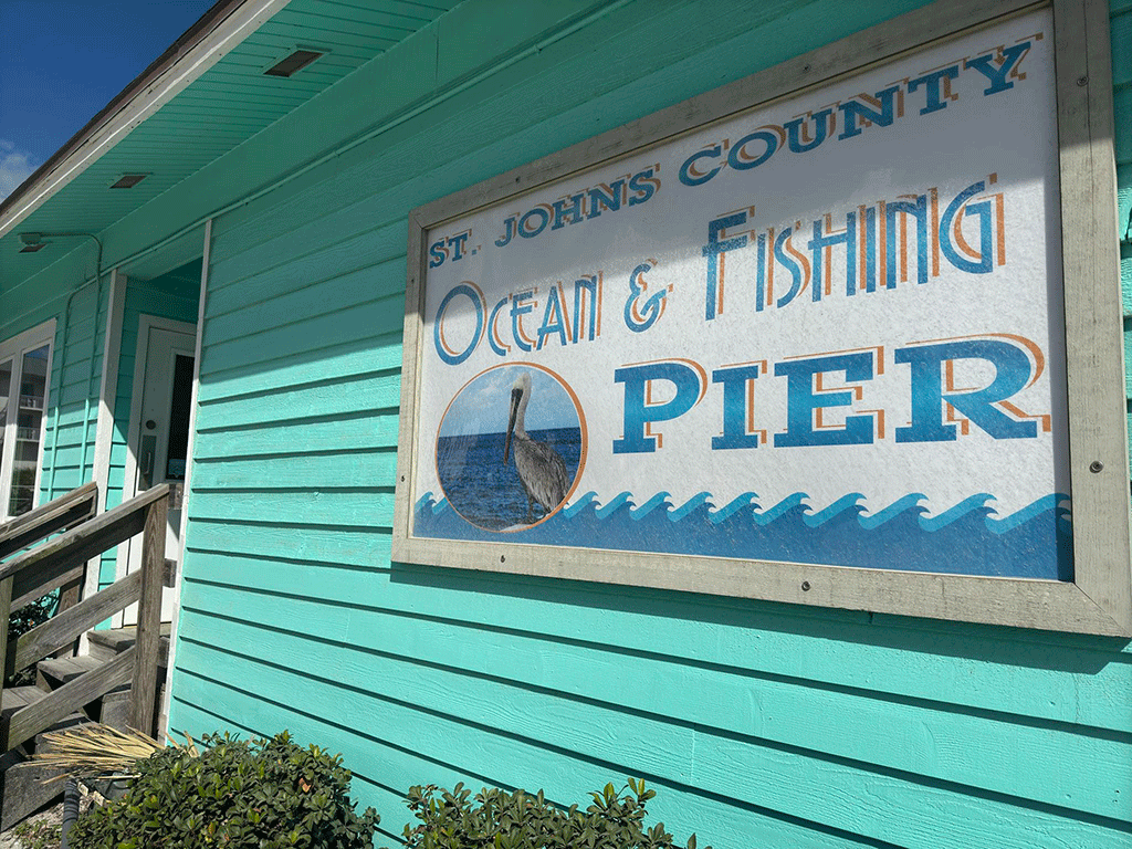 A sign for the St. Johns County Ocean and Fishing Pier.