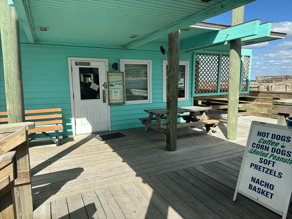 The side door of a gift shop underneath a covered area.