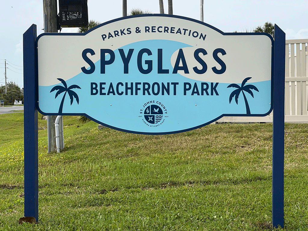 A sign for Spyglass Beachfront Park by the side of the road.