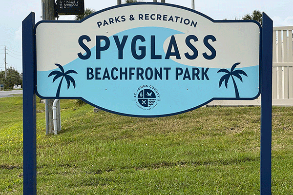 A sign for Spyglass Beachfront Park by the side of the road.
