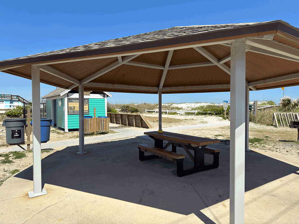 A small beach pavilion over a picnic table.