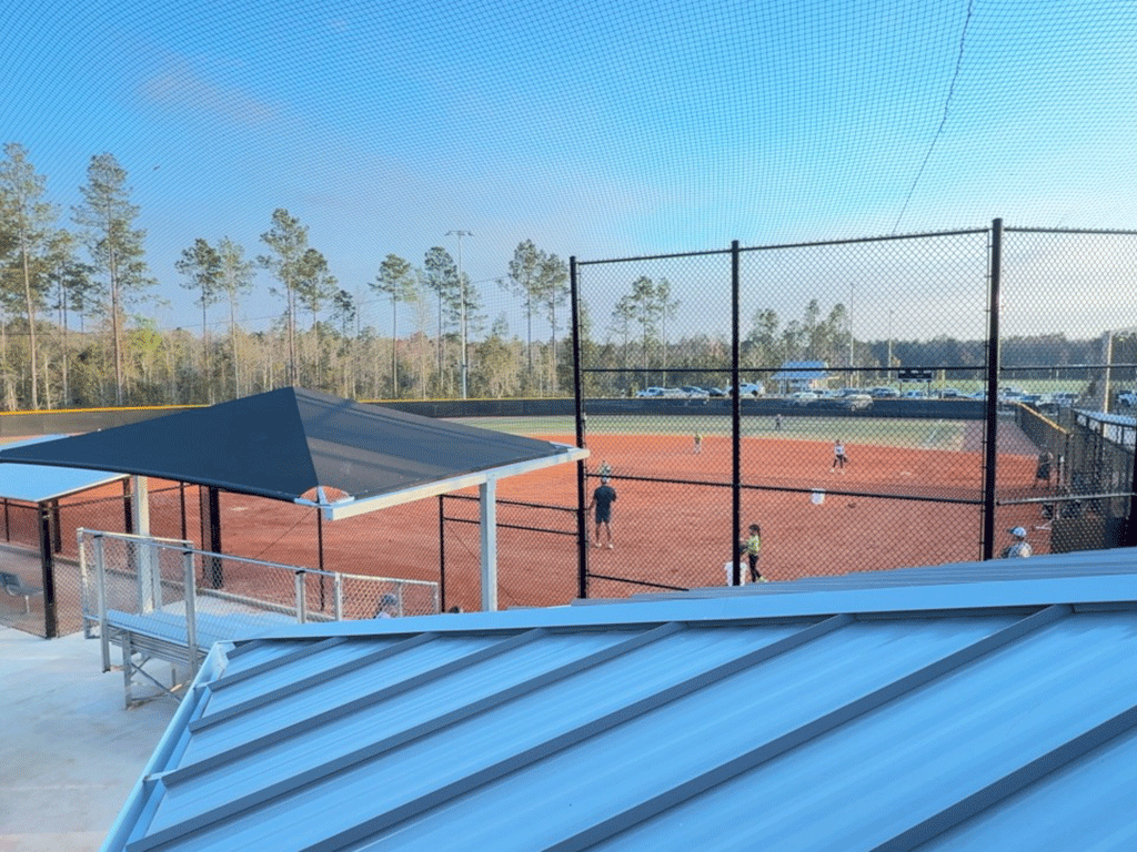 A high-angle view of people playing on a softball field.