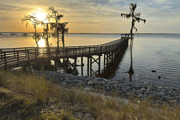 The sun sets over an Intracoastal fishing pier.