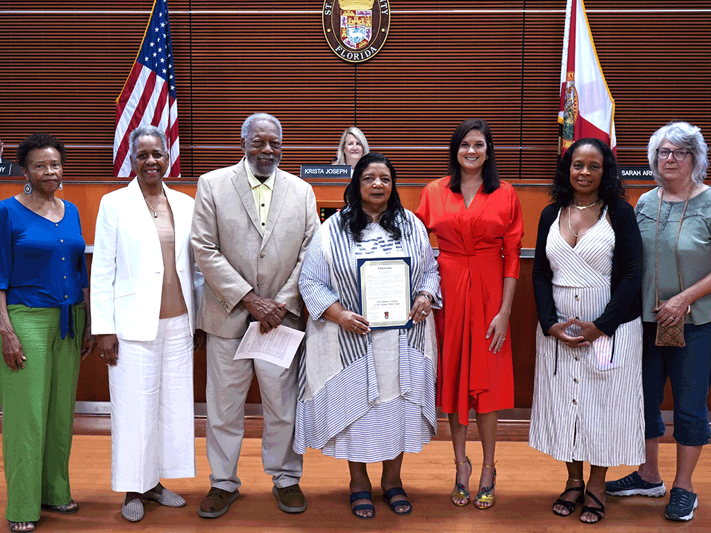 Gayle Phillips, Executive Director of the Lincolnville Museum, and Floyd Phillips, President of the Friends of Lincolnville (Lincolnville Museum & Cultural Center), accepted the proclamation with Commissioner Sarah Arnold and others.