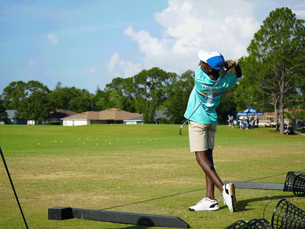 A golfer mid-swing out on the green.