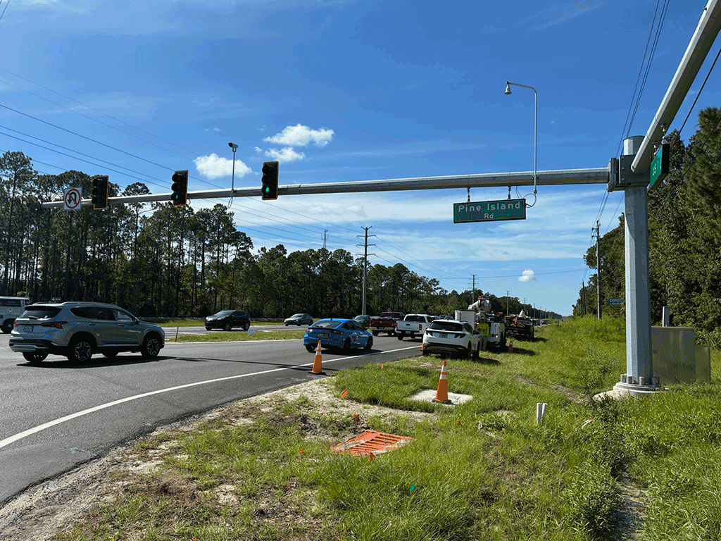 The Pine Island Road traffic signal's green light allows cars to proceed.