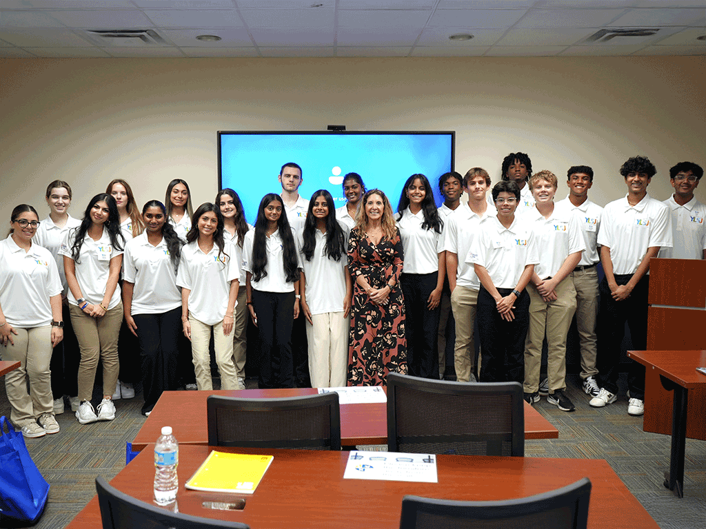 Commissioner Ann Taylor stands with students in the Youth Leadership St. Johns program.