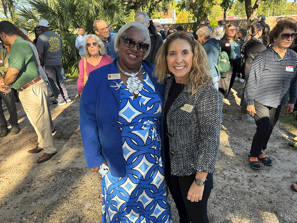 Commissioner Taylor and Commissioner Cynthia Garris smile at the camera