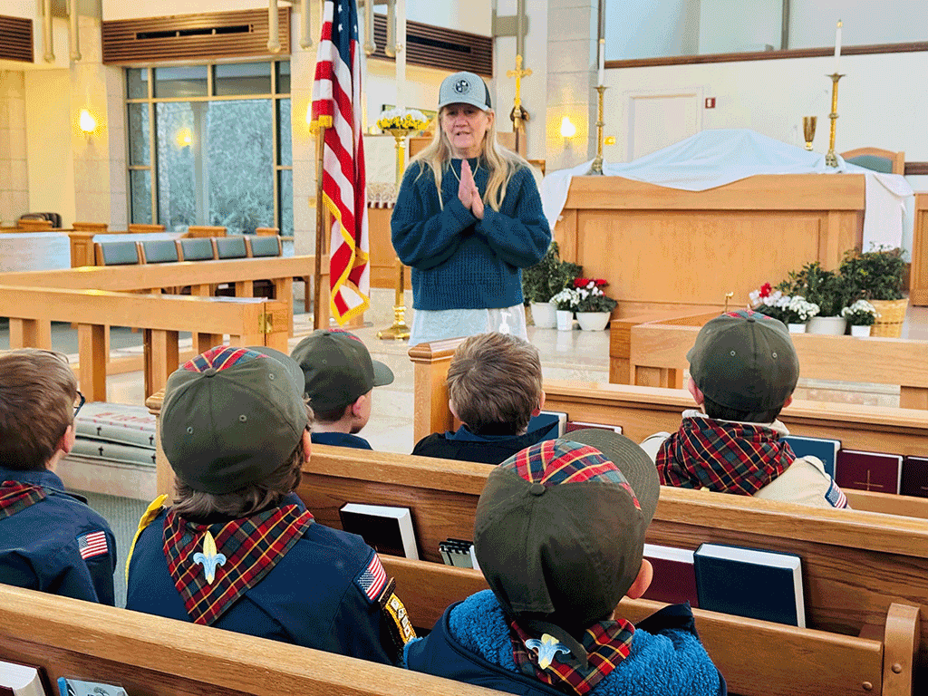 Commissioner Joseph speaking to boy scouts inside a church