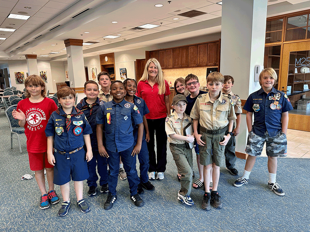 Commissioner Joseph stands with cub scouts