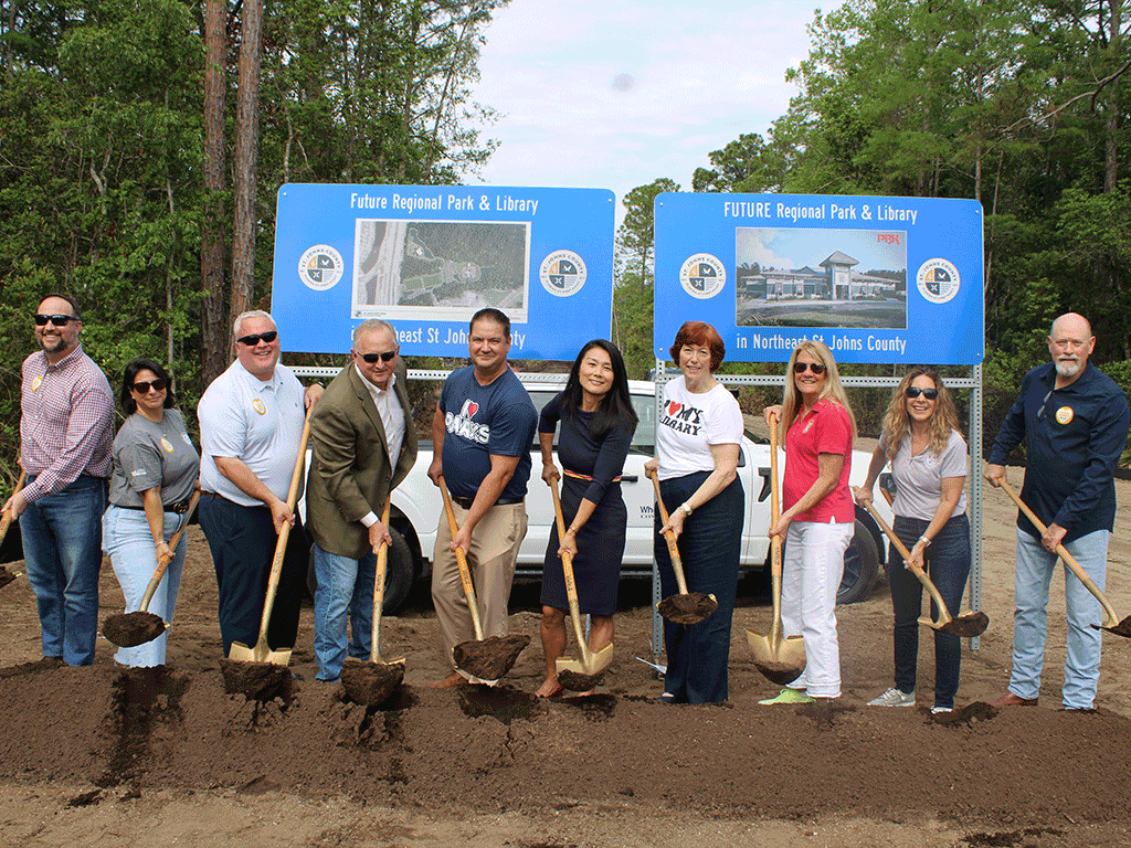 Commissioners Murphy, Joseph, Taylor, and Whitehurst, with Library Director Debra Rhodes Gibson, County Administrator Joy Andrews, Parks and Rec Director Ryan Kane, and others stand shoveling dirt