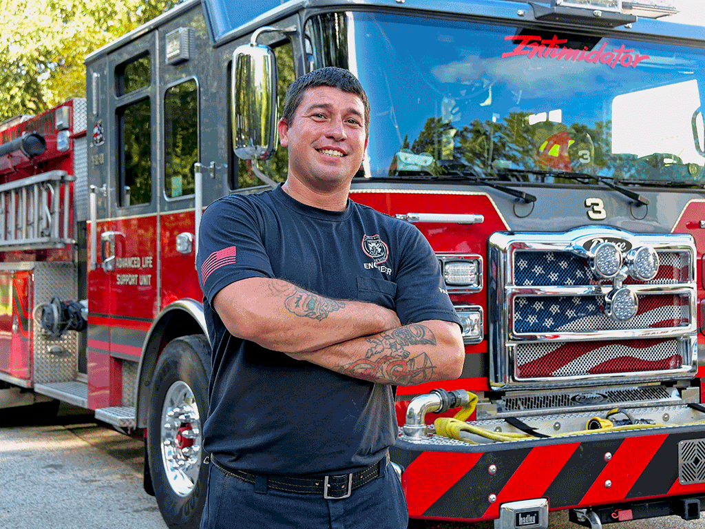 Engineer Charles Cook in front of Fire Truck